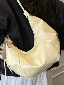 Minimalist beige hobo bag in glossy leather with stylish cloud pleats and shoulder strap