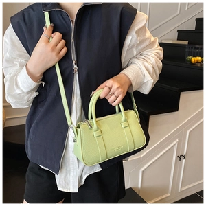 Detail of light green textured leather handbag with silver hardware and LIKE & BAGS logo