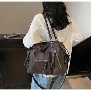 Detail of vintage dark brown tote showing high-quality lychee texture and zipper pockets