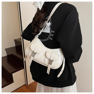 Dettaglio della borsa sottobraccio in pelle verniciata bianca con due tasche frontali e fibbie
