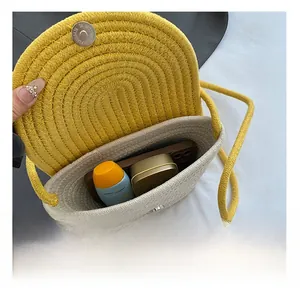 Detail view of the interior capacity of a woven crossbody bag for phone and cosmetics