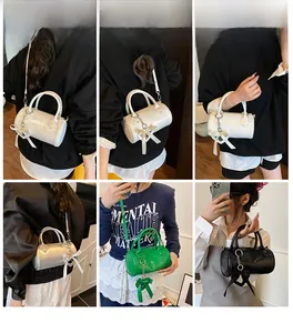 Collage of cylinder leather bags in four colors with ribbon bow and thin straps