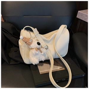 Detail of off-white lychee leather shoulder bag with cute teddy bear plush charm