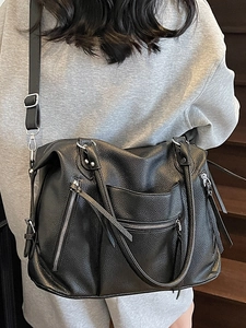 Retro black leather tote bag with silver zippers and large capacity for women on a shoulder