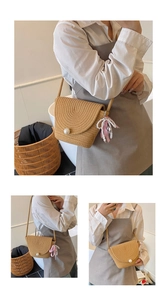 Detailed view of handmade woven straw bag with pearl closure and pink ribbon charm