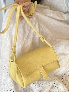 Elegant bright yellow pebble leather pillow bag with minimalist flap design for women