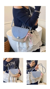 Detail of cute straw woven bag with light blue flap and elegant pearl closure
