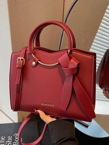 Fashionable wine red large tote bag with round metal handles and adjustable shoulder strap