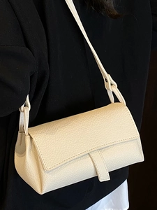 Minimalist beige lychee texture leather shoulder bag with flap closure on model