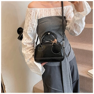 Petit sac bandoulière en cuir noir brillant avec surpiqûres blanches et bandoulière fine