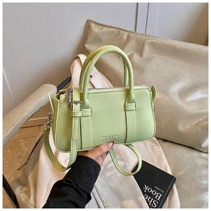 Close-up of mint green lychee pattern leather handbag with silver hardware details
