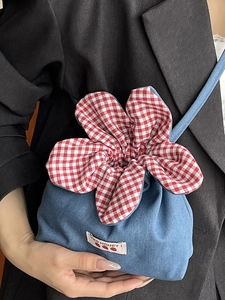 Blue corduroy bucket bag with large red floral drawstring and 'Yes Honey' patch