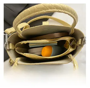 Top view showing the internal storage capacity and compartments of the yellow leather bucket bag