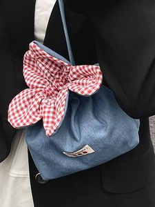 Cute denim floral drawstring crossbody bag with red gingham trim and strawberry label