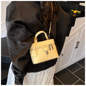 Detailed back view of a yellow lychee texture crossbody bag with silver chain and lock
