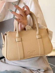 Chic beige lychee textured leather Boston bag with top handles and crossbody strap for women