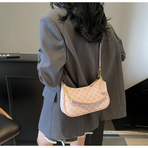 Detailed macro view of pink floral geometric moon bag with gold chain and thin shoulder strap