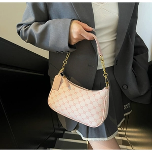 Detailed view of pink Monogram crescent bag with gold chain strap and leather brand tag