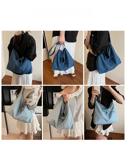 Close-up of denim canvas tote bag with ribbon bow and detailed letter embroidery