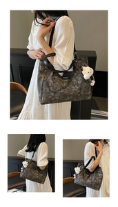 Detail view of large tote bag with floral pattern and cloud-shaped plush pendant charm