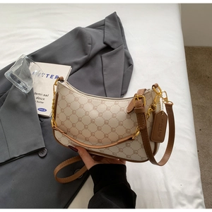 Close-up of geometric pattern hobo bag with gold hardware and brown leather trim