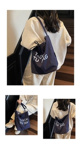 Detail of navy canvas tote bag with drawstring bow and blue checkered lining