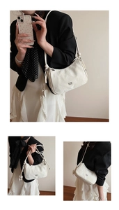 Detail of cream shoulder bag with knotted straps and detachable leather flower charm