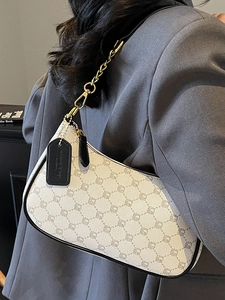 Chic beige crescent underarm bag with monogram print and golden chain strap for women