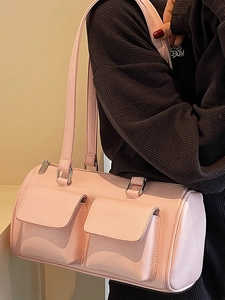 Pink patent leather cylindrical underarm bag with double front pockets and glossy finish