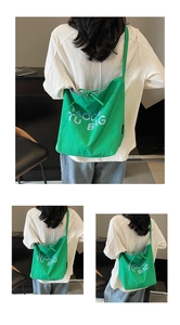 Detail of green canvas tote bag featuring white TUOCAI BAG letters and drawstring bow knot