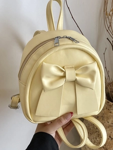 Cream yellow mini faux leather backpack with large bow detail and double zippers