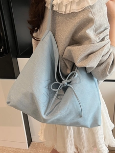 Light blue denim tote bag with bow detail and rhinestone accents for casual daily wear