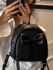 Mini black PU leather backpack for women featuring a large decorative bow and metal zippers