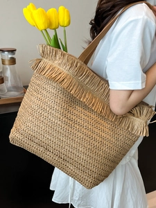 Große Strohtasche mit Fransenkante und Ledergriffen für den Sommerurlaub am Strand