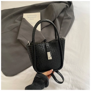 Detail of the intricate black woven leather texture and square silver metal clasp lock