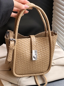 Brown woven bucket bag with top handle and crossbody strap in elegant leather texture