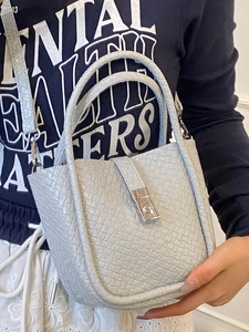 Chic light gray woven bucket bag with leather texture and silver buckle for women