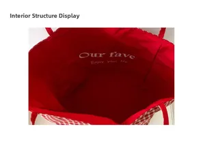 Detail view of the large capacity canvas tote bag showing the red lining and interior structure