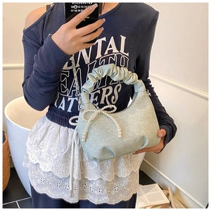 Chic ruched cloud handbag in mint green with pearl bow detail and silver chain strap