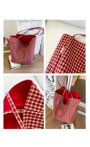 Close-up of red gingham nylon tote bag featuring red lining and branded side label