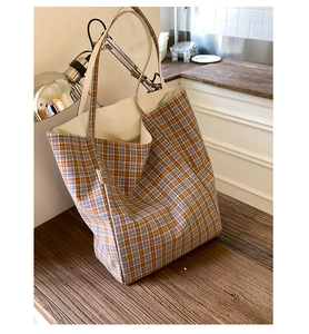 Close-up of the orange and blue checkered tote bag with a small white side label