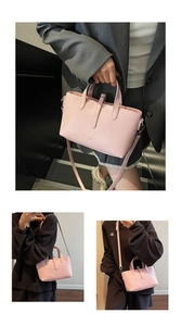 Detail of pink crocodile embossed tote bag showing texture and various styling options