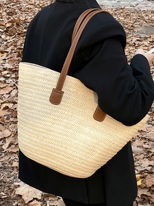 Handwoven straw tote bag with brown leather straps for beach vacation and daily use