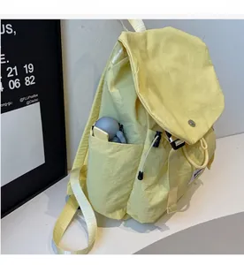 Detail view of the durable side pocket and light yellow nylon fabric on a leisure backpack