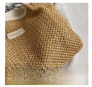 Detailed macro view of woven straw texture with white leather trim and silver metal hardware