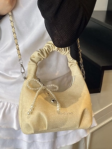 Chic beige pleated cloud bag with pearl bow charm and silver chain strap for women