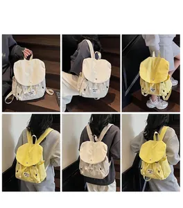 Detail showing the drawstring and flap closure of this stylish cream canvas backpack