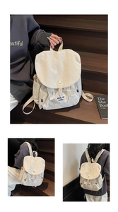 Close-up of beige canvas backpack with flap buckle and detailed brand label patch