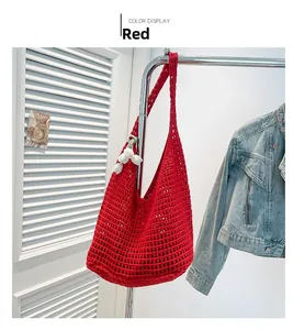 Detail view of red hollow-out crochet beach bag with white 3D flower charm pendant