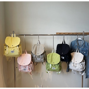 Detailed display of casual nylon backpacks in six colors with flap-top drawstring closures